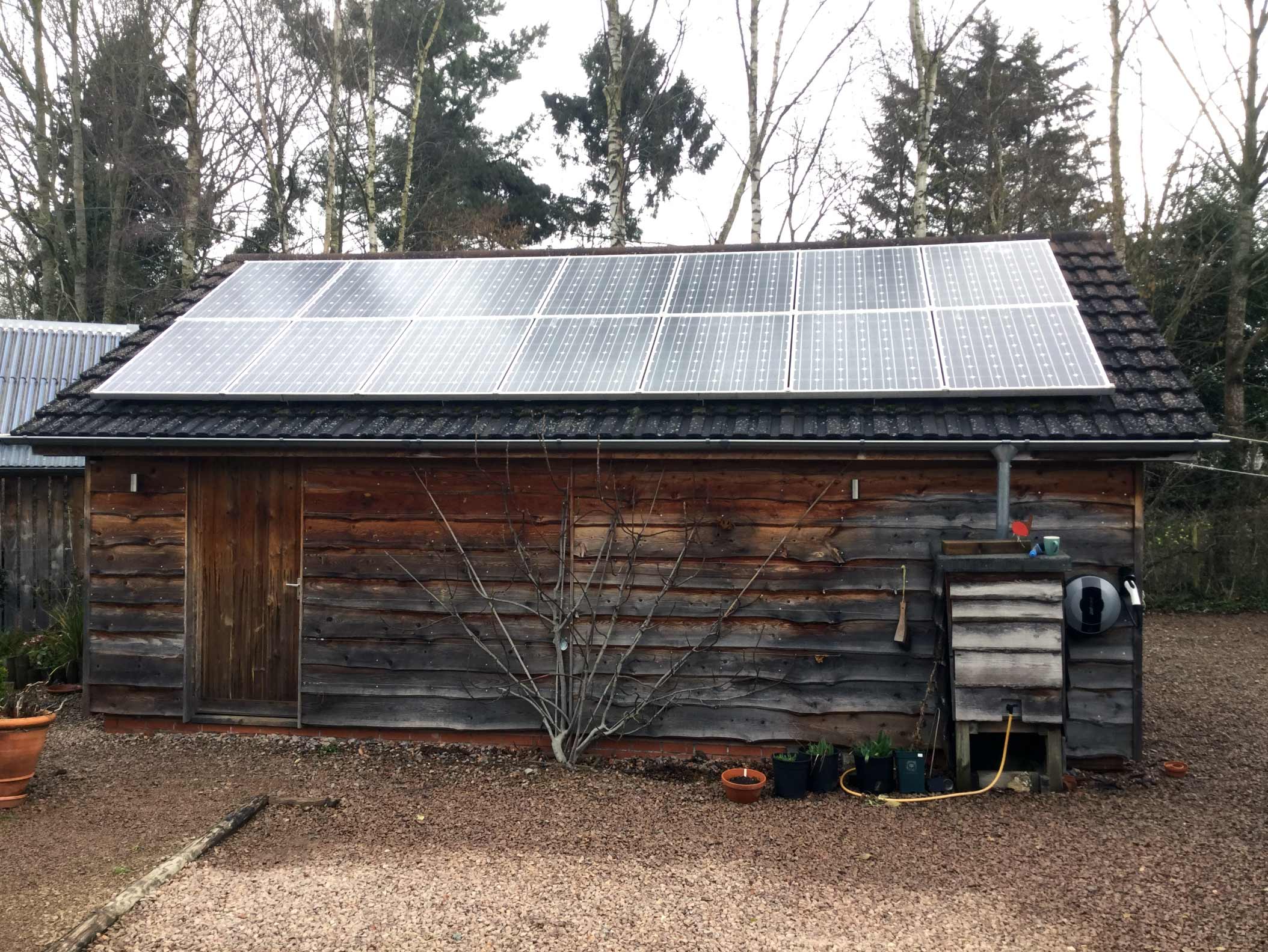 Pod Point on barn with solar panels