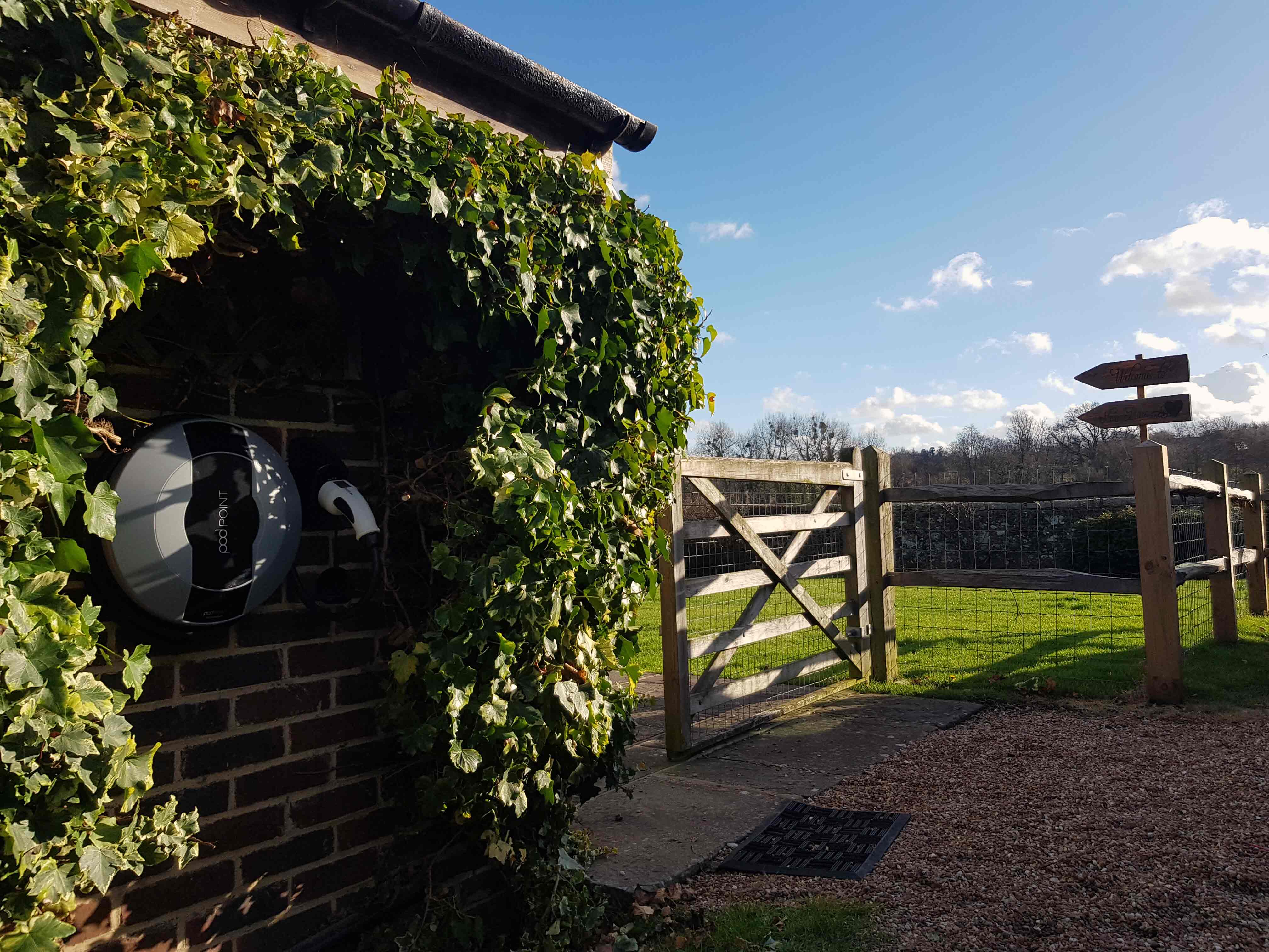 Pod Point on brick wall with ivy