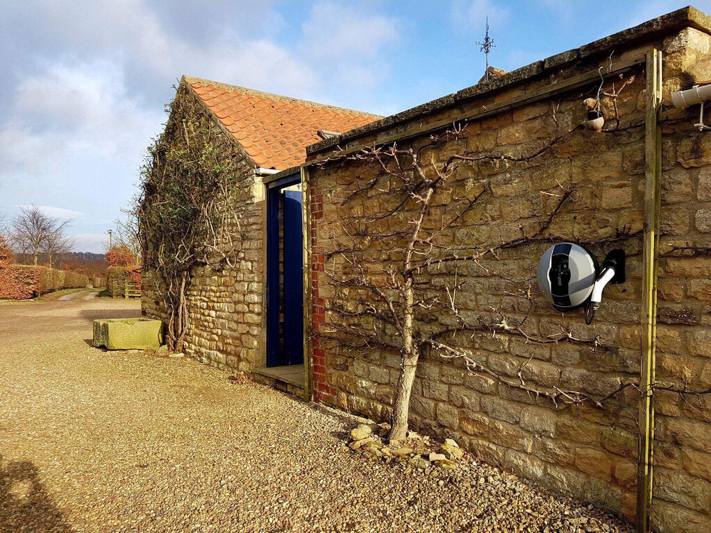 Pod Point on stone wall house